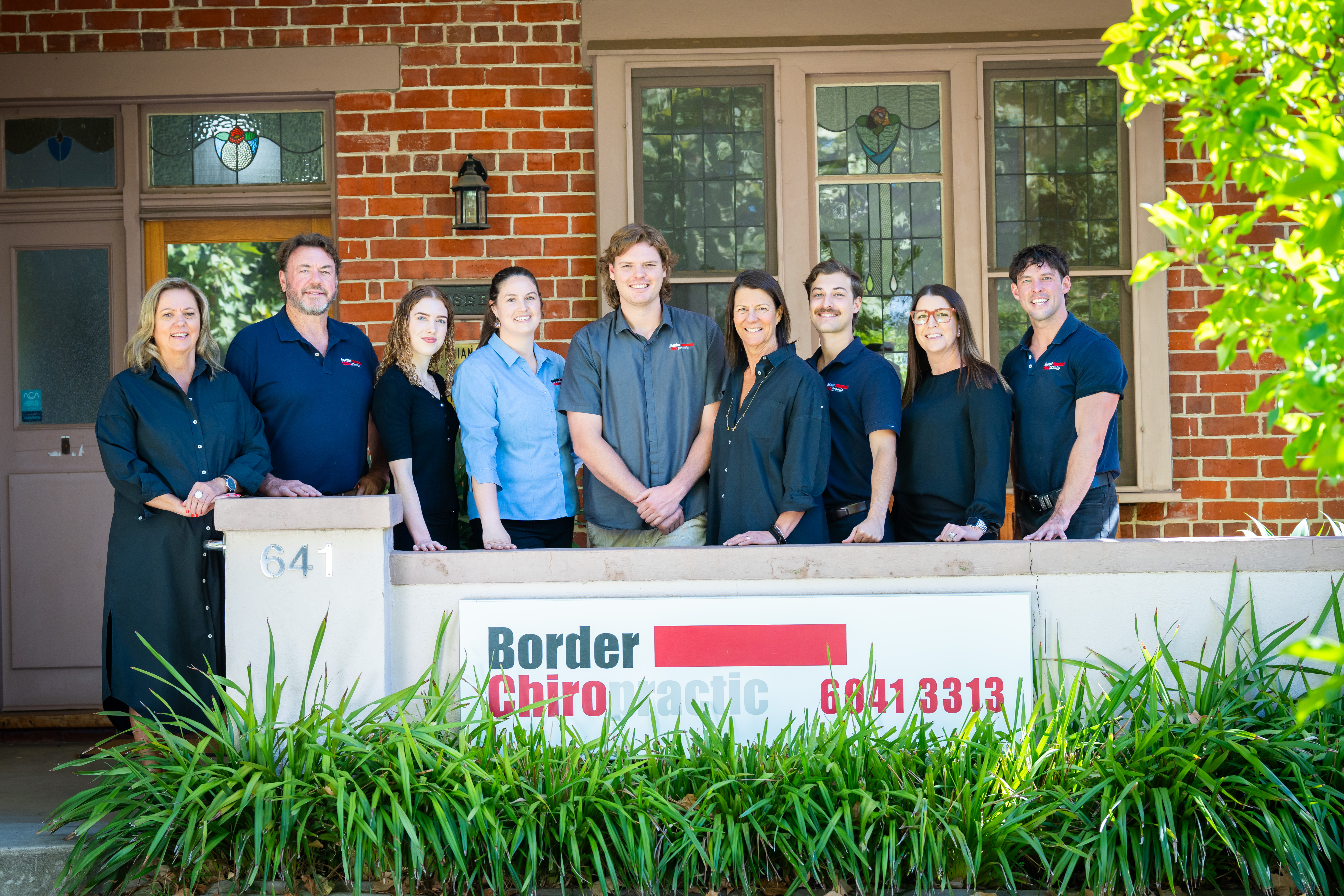 team in front of building